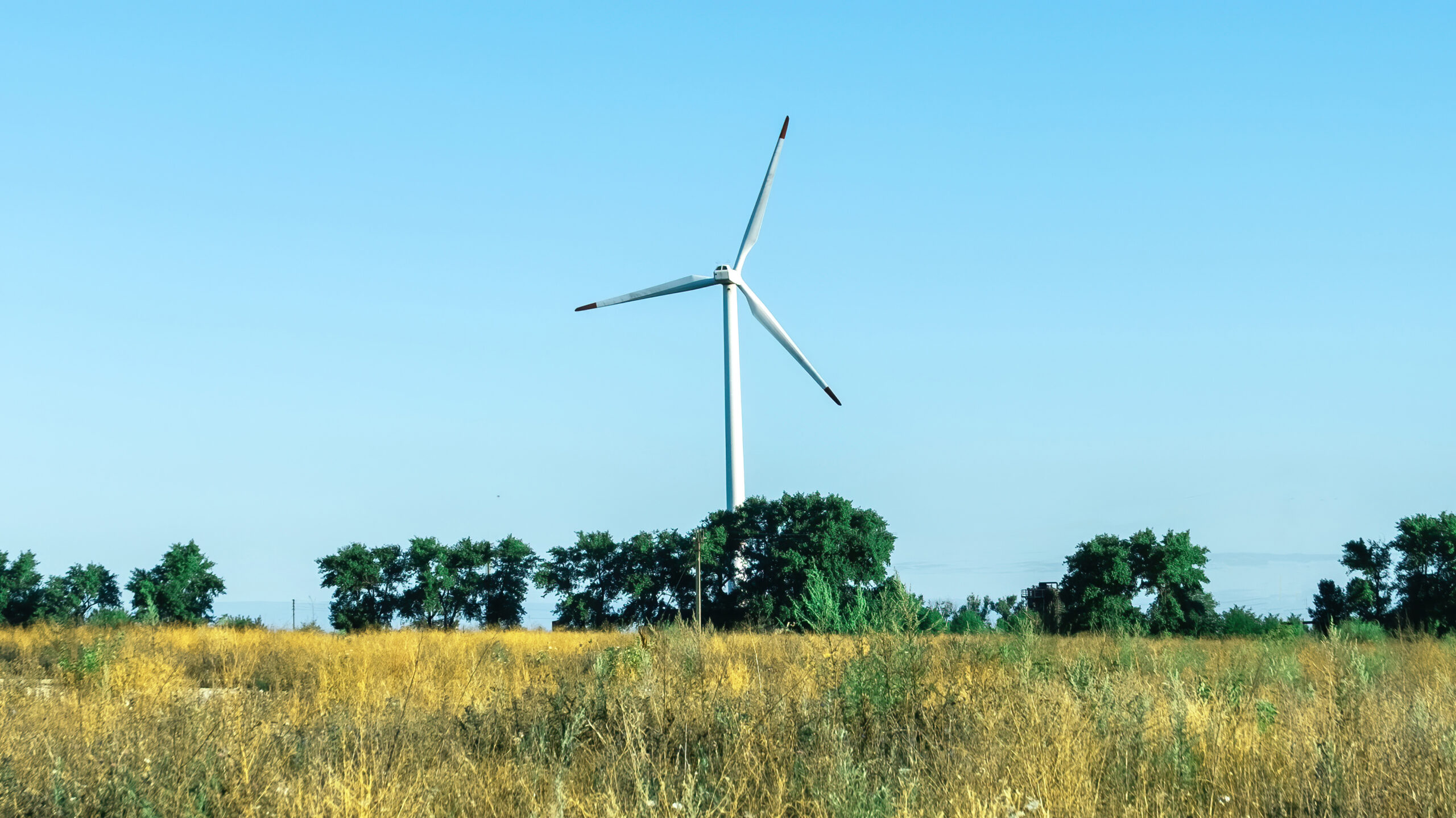 Modern Wind Turbines Against Blue Sky Scaled